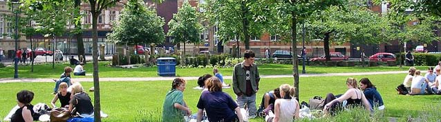 Photograph of people sitting around in All Saint's Park