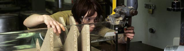 Photograph of a student using a machine in a workshop