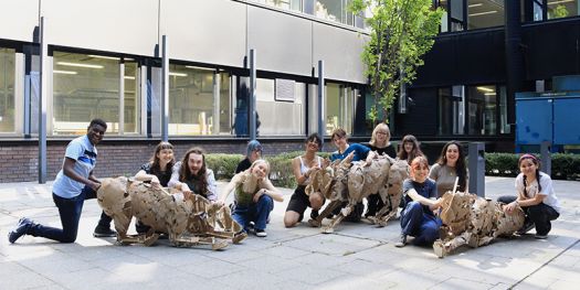 A group of students who created the models at workshops at Manchester Met